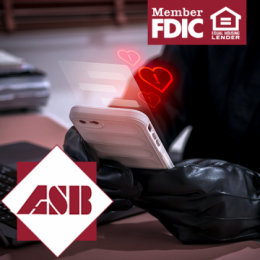 Person's torso and hands in all black clothing and gloves holding smartphone with red hearts coming from it that have exclamation points in them
