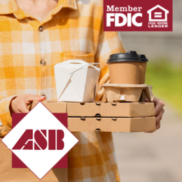 Person walking outside with takeout boxes and takeout coffee