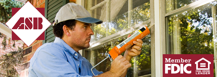 Guy fixing up his window outside of his house