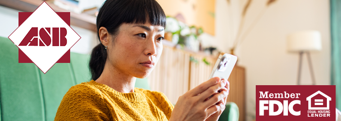 Woman holding phone and staring at screen