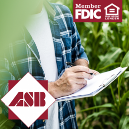 Farmer standing in the field writing on a clipboard